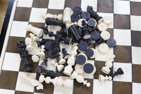 A 1930s ivory and tortoiseshell chess board and a 19th century ivory chess and draughts sets